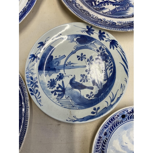 404 - Twenty three pieces of blue and white ceramics to include four Willow pattern meat plates, Delftware... 