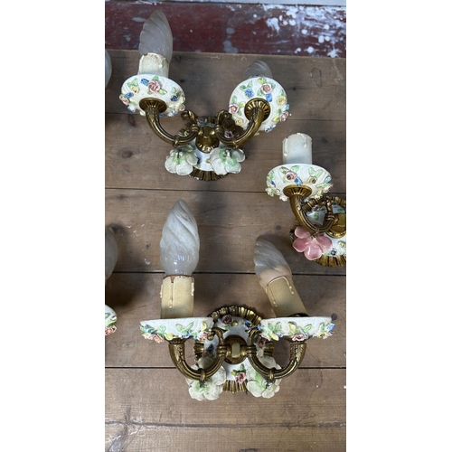 17 - Six pieces of 19th century style brass and floral decorated porcelain lighting, five wall sconces an... 