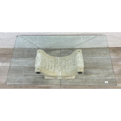 65 - A modern limestone effect fibreglass and bevelled glass top coffee table - approx. 43cm high x 76cm ... 