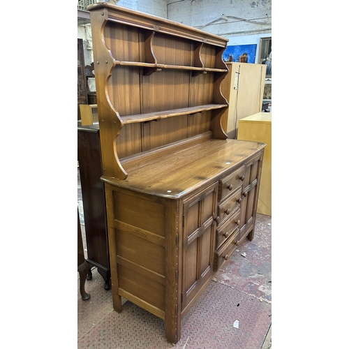 66 - An Ercol Golden Dawn elm and beech dresser - approx. 170cm high x 146cm wide x 50cm deep