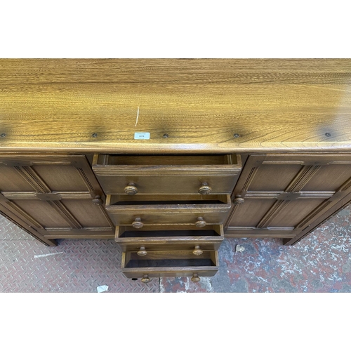 66 - An Ercol Golden Dawn elm and beech dresser - approx. 170cm high x 146cm wide x 50cm deep