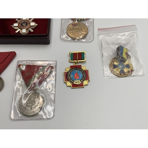 2369 - Nine Eastern European military medals to include Ukraine Order for Courage, Bulgarian Cross of Brave... 