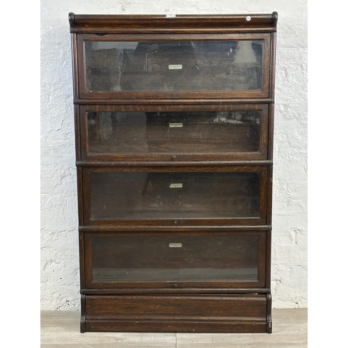 1 - An early 20th century Globe-Wernicke oak four section stacking bookcase - approx. 141cm high x 86cm ... 