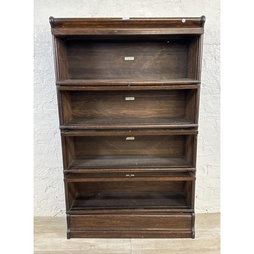 1 - An early 20th century Globe-Wernicke oak four section stacking bookcase - approx. 141cm high x 86cm ... 