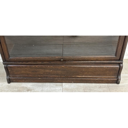 1 - An early 20th century Globe-Wernicke oak four section stacking bookcase - approx. 141cm high x 86cm ... 