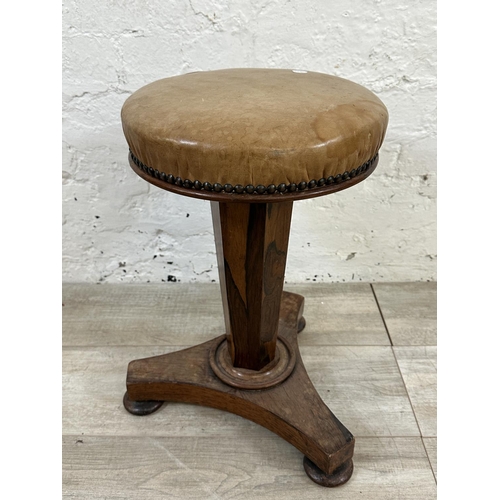 10 - A Victorian rosewood revolving piano stool with tan vinyl seat - approx. 56cm high