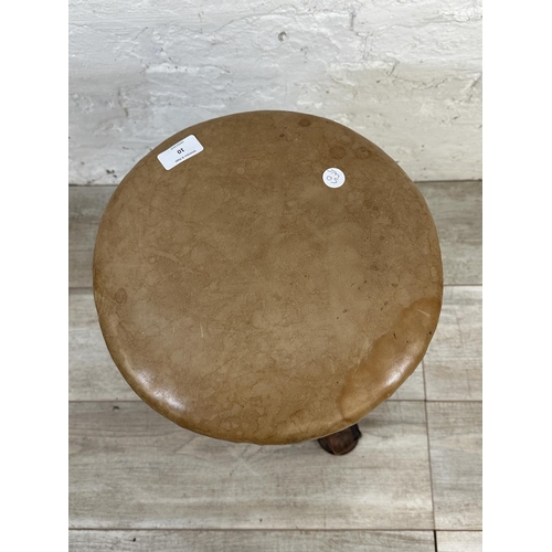 10 - A Victorian rosewood revolving piano stool with tan vinyl seat - approx. 56cm high