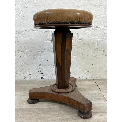 10 - A Victorian rosewood revolving piano stool with tan vinyl seat - approx. 56cm high