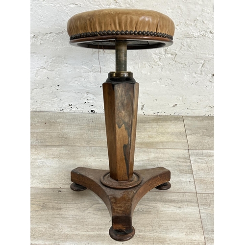 10 - A Victorian rosewood revolving piano stool with tan vinyl seat - approx. 56cm high