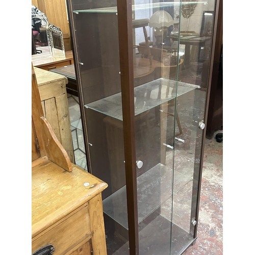 101 - A modern walnut effect and glass display cabinet with three glass shelves - approx. 172cm high x 58c... 