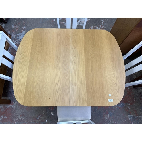 107 - A modern oak effect and white painted extending dining table and four chairs - approx. 74cm high x 8... 