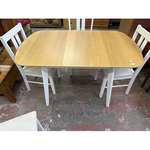 107 - A modern oak effect and white painted extending dining table and four chairs - approx. 74cm high x 8... 