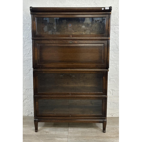 2 - An early 20th century Globe-Wernicke oak four section stacking bookcase - approx. 147cm high x 86cm ... 