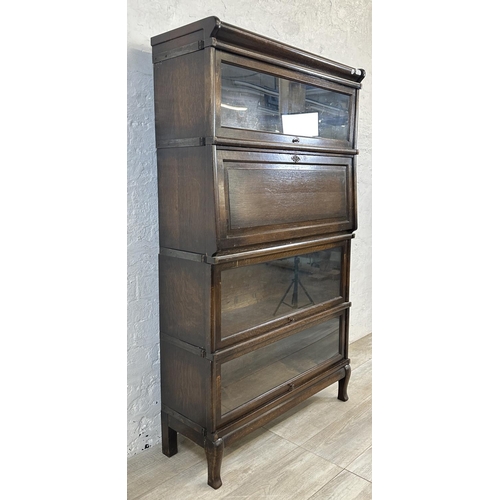 2 - An early 20th century Globe-Wernicke oak four section stacking bookcase - approx. 147cm high x 86cm ... 