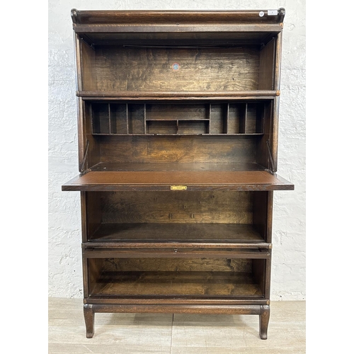 2 - An early 20th century Globe-Wernicke oak four section stacking bookcase - approx. 147cm high x 86cm ... 