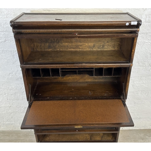 2 - An early 20th century Globe-Wernicke oak four section stacking bookcase - approx. 147cm high x 86cm ... 