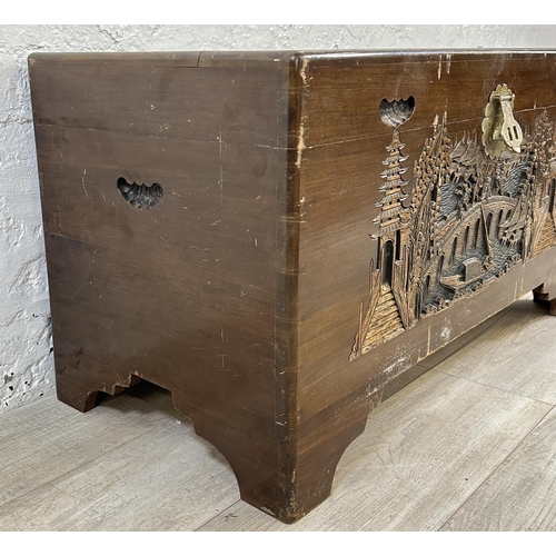 20 - A Chinese carved camphor wood blanket box - approx. 50cm high x 91cm wide x 45cm deep