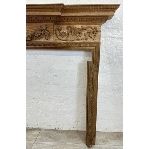 22 - A 19th century style carved pine fire surround - approx. 146cm high x 152cm wide x 24cm deep