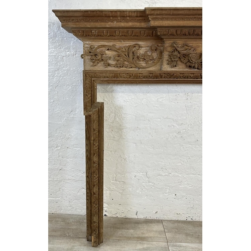 22 - A 19th century style carved pine fire surround - approx. 146cm high x 152cm wide x 24cm deep