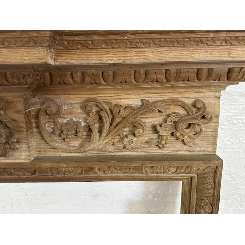 22 - A 19th century style carved pine fire surround - approx. 146cm high x 152cm wide x 24cm deep