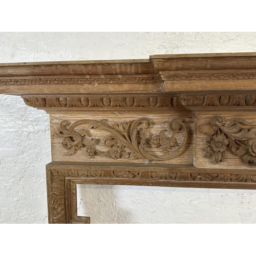 22 - A 19th century style carved pine fire surround - approx. 146cm high x 152cm wide x 24cm deep