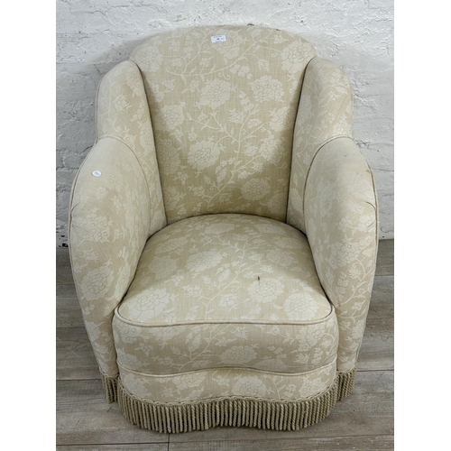 23 - Two pieces of upholstered furniture, one Art Deco style floral fabric armchair and one tapestry foot... 