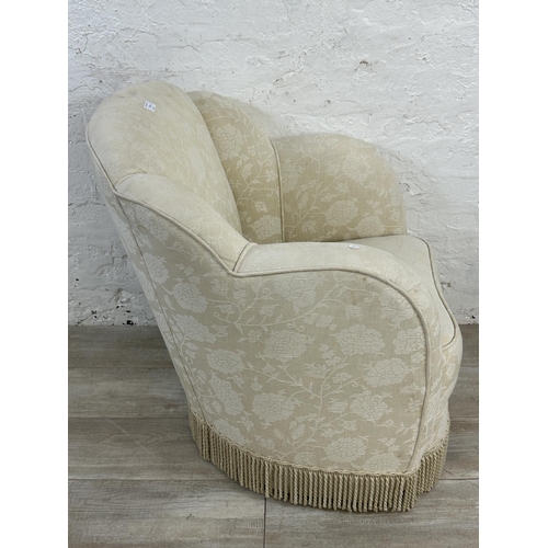 23 - Two pieces of upholstered furniture, one Art Deco style floral fabric armchair and one tapestry foot... 