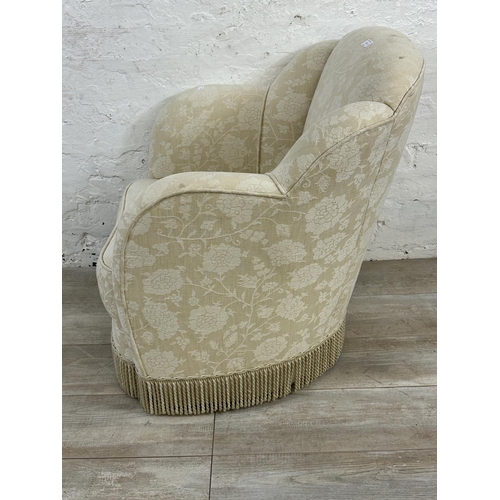 23 - Two pieces of upholstered furniture, one Art Deco style floral fabric armchair and one tapestry foot... 