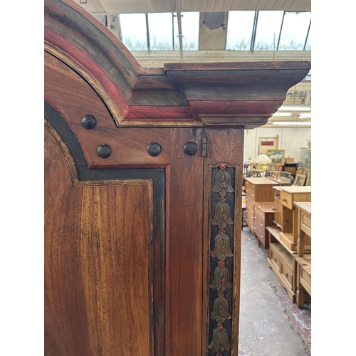 26 - A Chinese hand painted and carved hardwood two door cabinet - approx. 199cm high x 150cm wide x 59cm... 