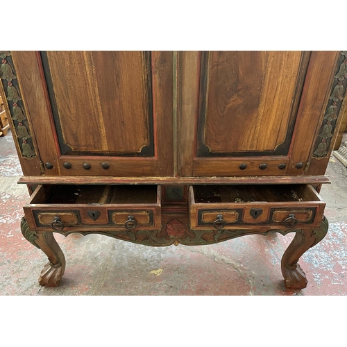 26 - A Chinese hand painted and carved hardwood two door cabinet - approx. 199cm high x 150cm wide x 59cm... 