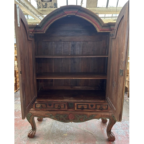 26 - A Chinese hand painted and carved hardwood two door cabinet - approx. 199cm high x 150cm wide x 59cm... 