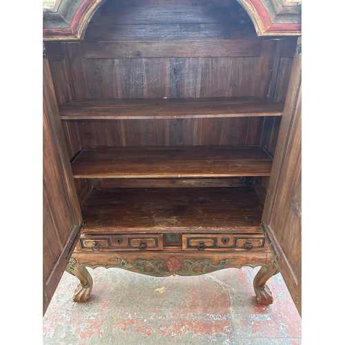 26 - A Chinese hand painted and carved hardwood two door cabinet - approx. 199cm high x 150cm wide x 59cm... 