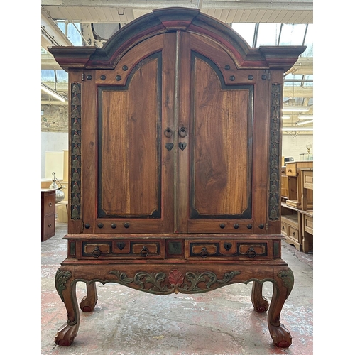 26 - A Chinese hand painted and carved hardwood two door cabinet - approx. 199cm high x 150cm wide x 59cm... 