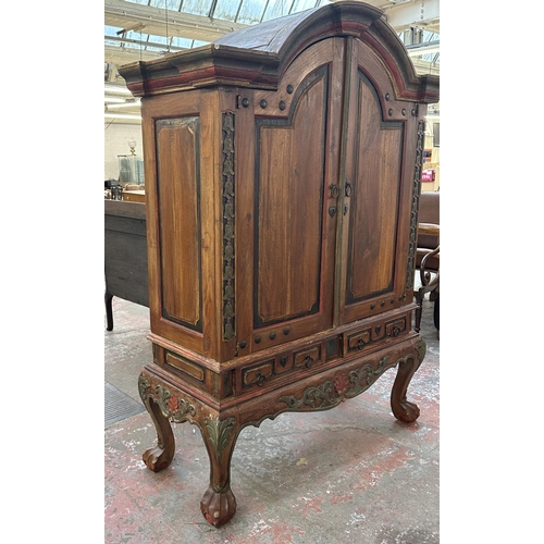 26 - A Chinese hand painted and carved hardwood two door cabinet - approx. 199cm high x 150cm wide x 59cm... 