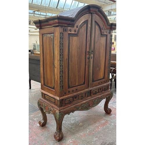 26 - A Chinese hand painted and carved hardwood two door cabinet - approx. 199cm high x 150cm wide x 59cm... 