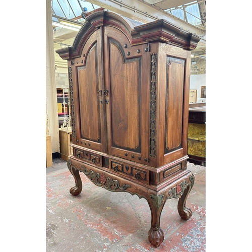 26 - A Chinese hand painted and carved hardwood two door cabinet - approx. 199cm high x 150cm wide x 59cm... 