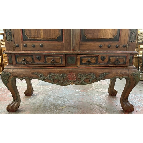 26 - A Chinese hand painted and carved hardwood two door cabinet - approx. 199cm high x 150cm wide x 59cm... 