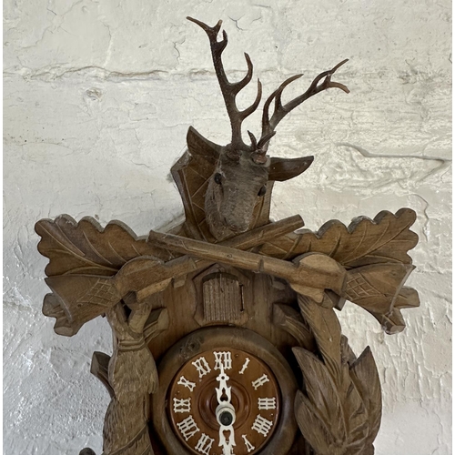 29 - A mid 20th century West German Black Forest carved wooden cuckoo clock - approx. 49cm high including... 