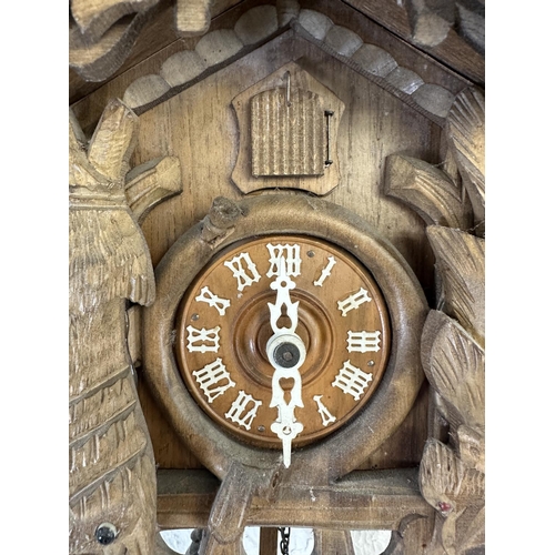 29 - A mid 20th century West German Black Forest carved wooden cuckoo clock - approx. 49cm high including... 