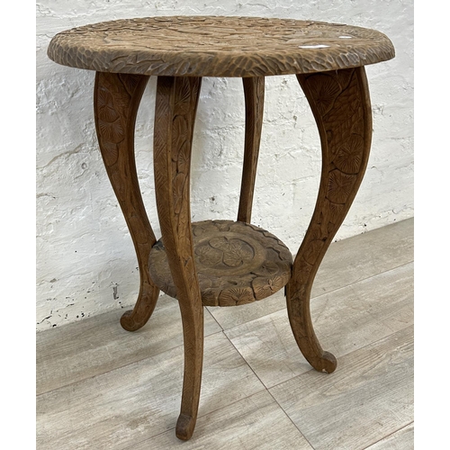 30 - An Arts & Crafts Liberty & Co carved hardwood circular side table with three monkey design and numbe... 