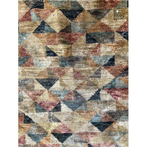 36 - A modern multicoloured machine woven rug - approx. 176cm x 122cm