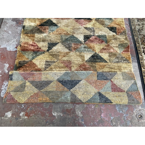 36 - A modern multicoloured machine woven rug - approx. 176cm x 122cm