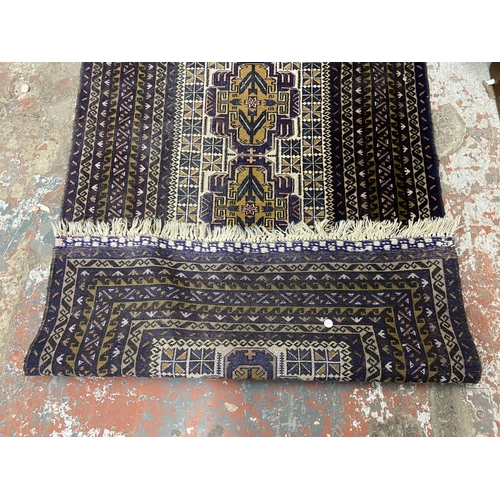 37 - An Afghan blue ground rug - approx. 150cm x 95cm