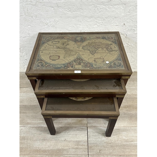 4 - A mid 20th century mahogany and brass nest of three tables with map of the world design - approx. 46... 