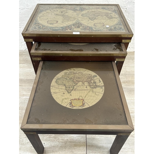 4 - A mid 20th century mahogany and brass nest of three tables with map of the world design - approx. 46... 