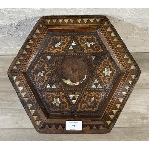 40 - A late 19th/early 20th century Moorish inlaid hardwood hexagonal side table - approx. 47cm high x 33... 