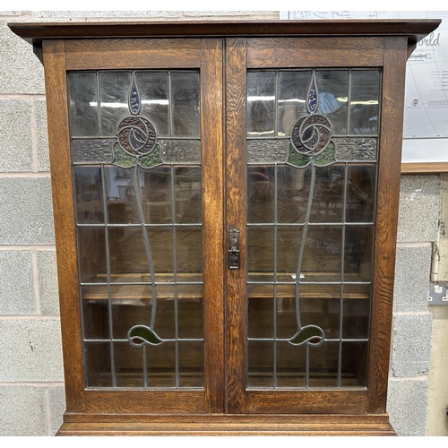 43 - An early 20th century oak bureau bookcase with two stained and lead glazed doors - approx. 194cm hig... 