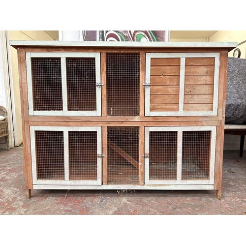 47 - A wooden two tier rabbit hutch - approx. 113cm high x 152cm wide x 61cm deep