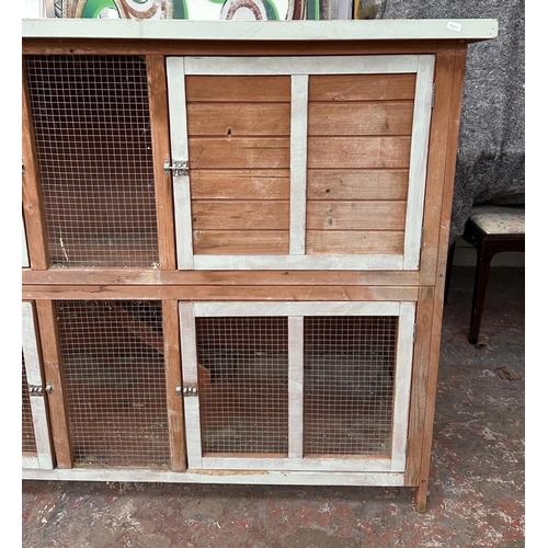 47 - A wooden two tier rabbit hutch - approx. 113cm high x 152cm wide x 61cm deep