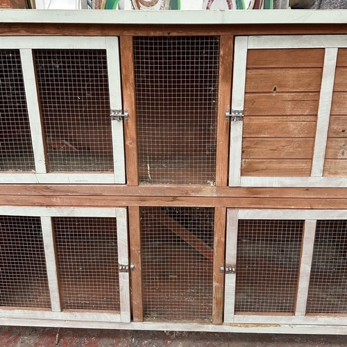 47 - A wooden two tier rabbit hutch - approx. 113cm high x 152cm wide x 61cm deep